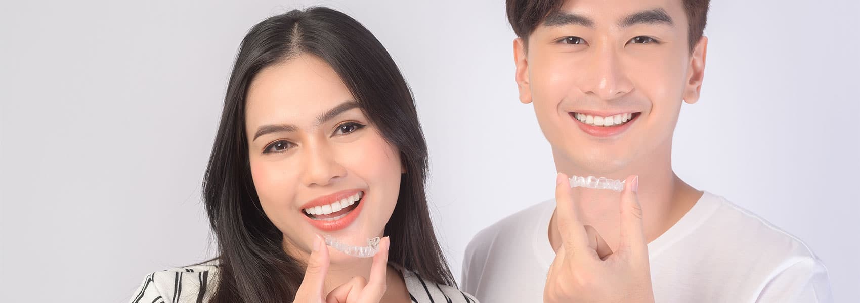 Beautiful couple smiling with mouth guards